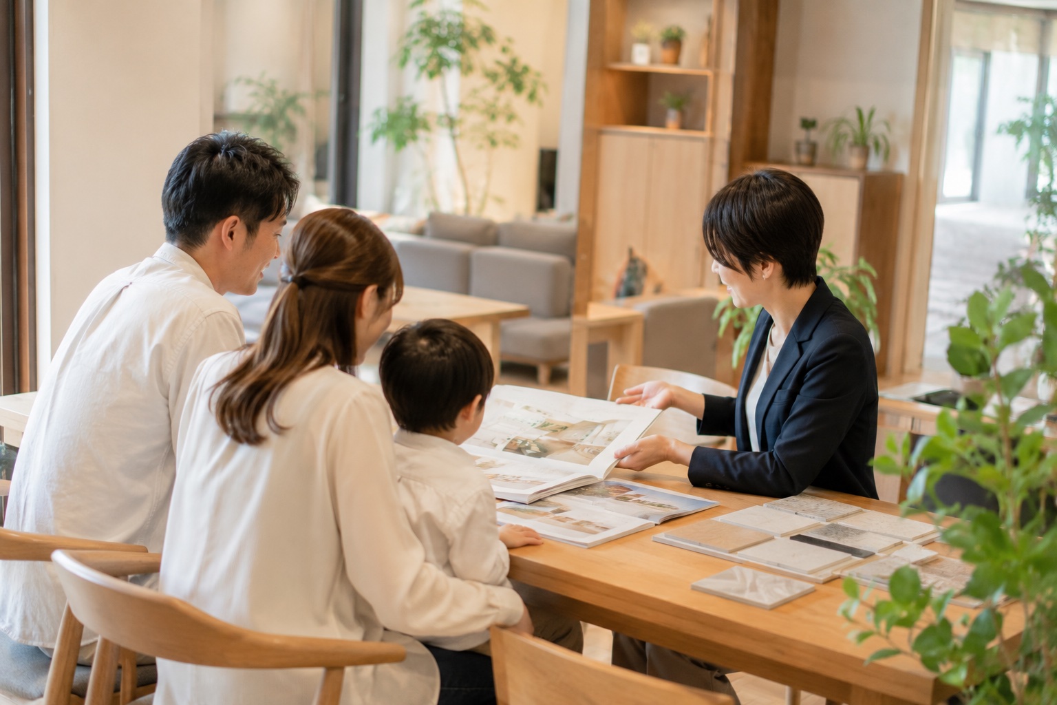 テーブルを囲んで家族と設計士が家づくりについて話し合う様子
